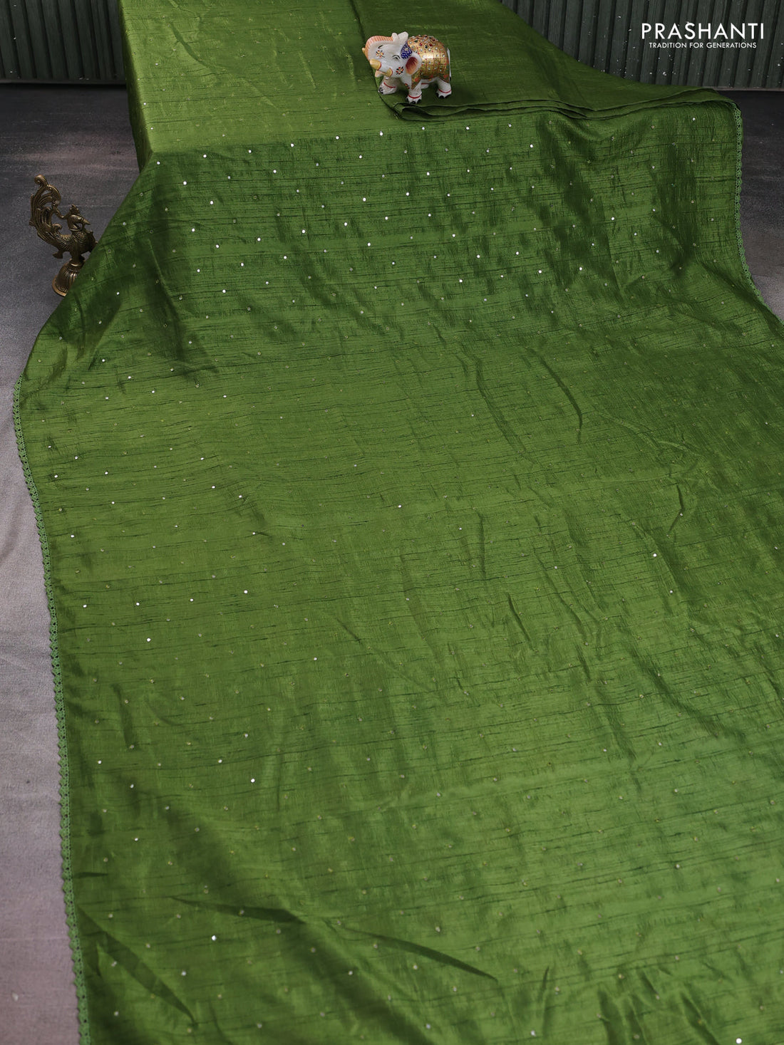 Semi raw silk saree light green with allover mirror work and lace work border